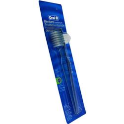 Eine Zahnbürste für Prothesen in einer blauen Verpackung.